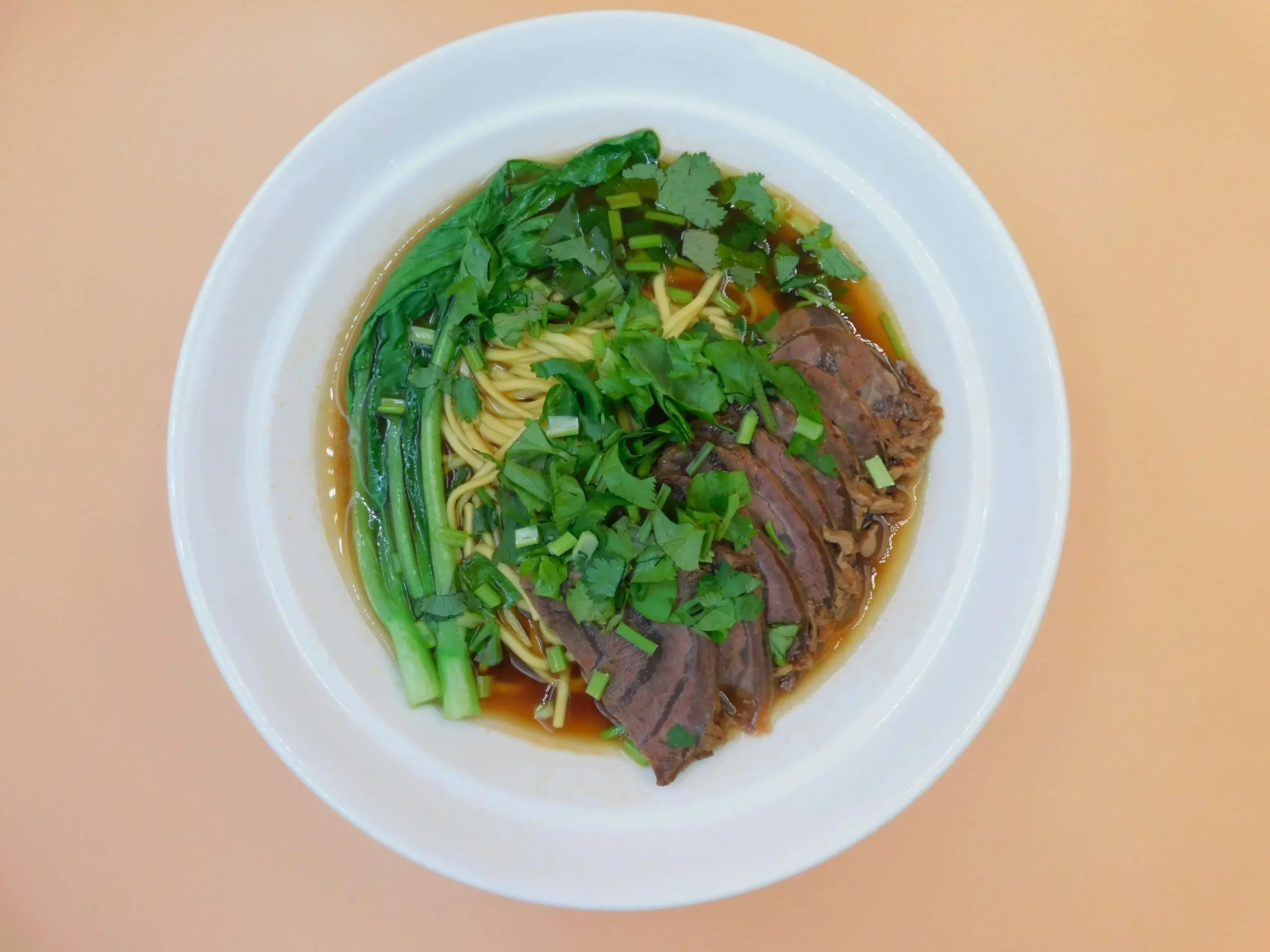 Impressive-Noodle&Okinii-Japanese-Restaurant-Asian-Fusion-Restaurant-Beef-Slice-Noodle-Soup-Massapequa Beef slice noodle soup with fresh cilantro and greens at Impressive Noodle & Okinii Japanese Restaurant, a Asian Fusion Restaurant in Massapequa