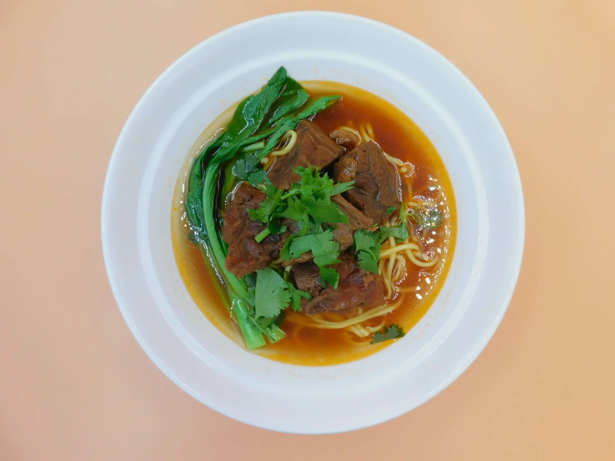Impressive-Noodle&Okinii-Japanese-Restaurant-Asian-Fusion-Restaurant-Spicy-Beef-Noodle-Soup-Massapequa Spicy beef noodle soup with tender beef chunks and greens at Impressive Noodle & Okinii Japanese Restaurant, a Asian Fusion Restaurant in Massapequa