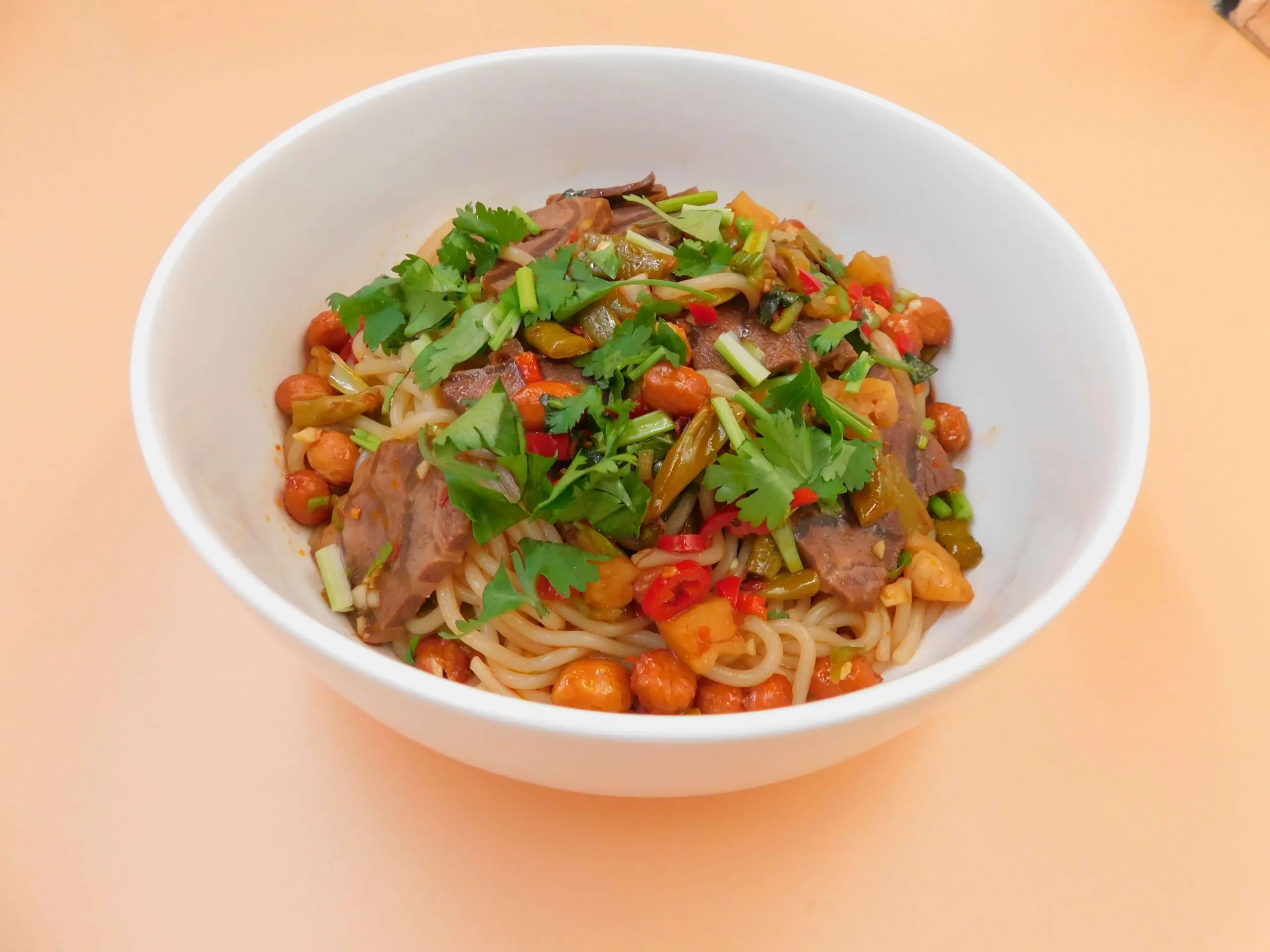 Spicy dry noodles with beef, peanuts and cilantro at Impressive Noodle & Okinii Japanese Restaurant, a Asian Fusion Restaurant in Massapequa