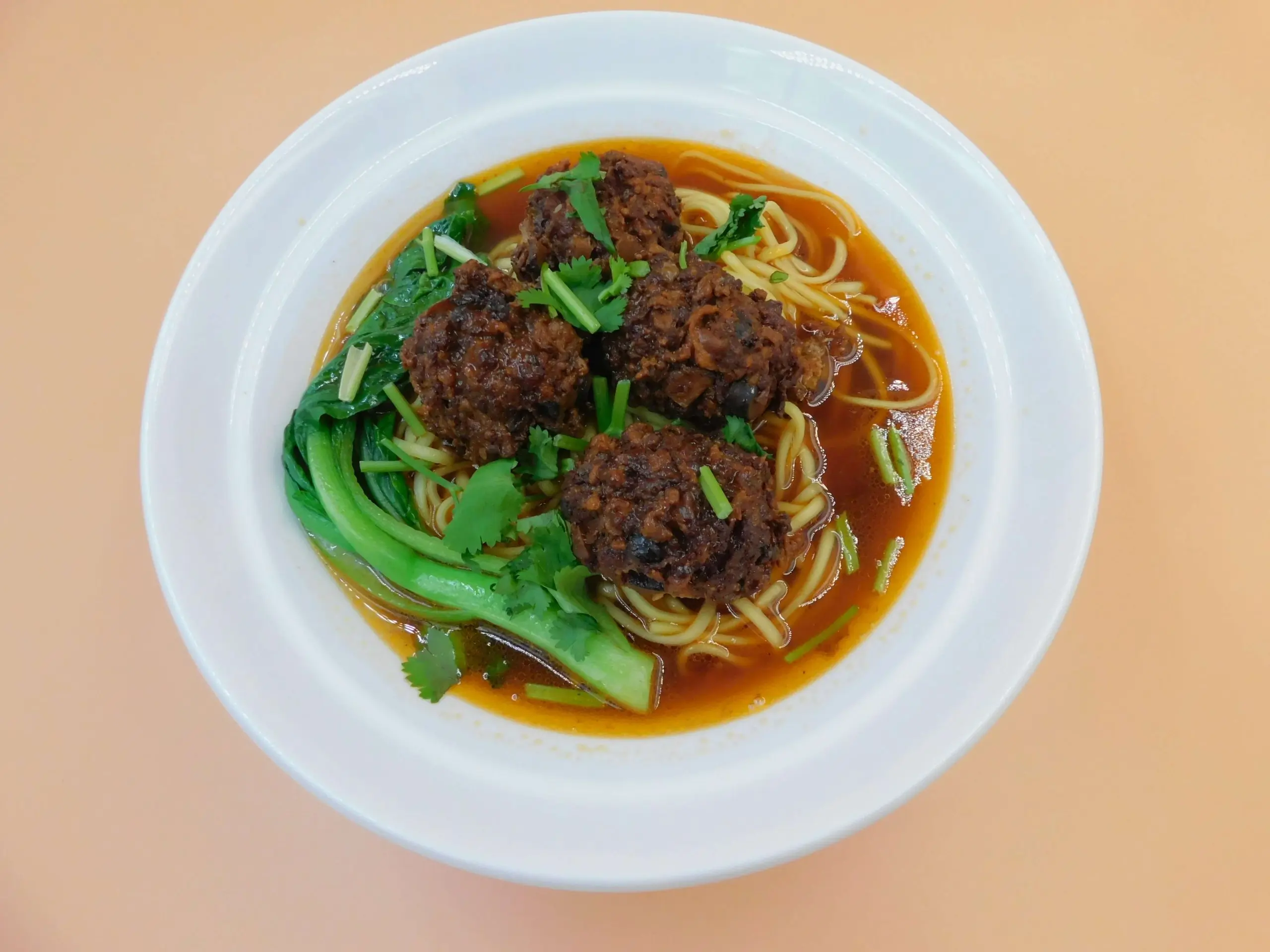 Impressive-Noodle&Okinii-Japanese-Restaurant-Asian-Fusion-Restaurant-Meatball-Noodle-Soup-Massapequa Noodle soup with meatballs, greens and cilantro at Impressive Noodle & Okinii Japanese Restaurant, a Asian Fusion Restaurant in Massapequa